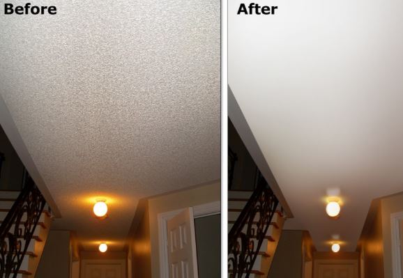 Drywall contractor working on removing popcorn ceiling texture in a home, demonstrating the ceiling refinishing process.